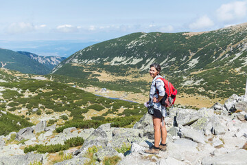 Fototapeta premium Hiker Woman in Rila Mountain with Stunning View. Musala Peak in Bulgaria in the Summer 