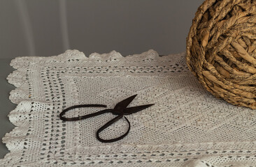 Old rusty scissors on white crochet table mat. Antique japanese bonsai scissors.