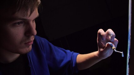 Artist copyist paint seascape with ship in ocean. Craftsman decorator draw as boat sail on blue sea with acrylic oil color. Draw finger, brush, knife palette. Canvas, easel in studio, indoor.