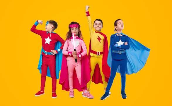 Team of children in superhero costumes in studio