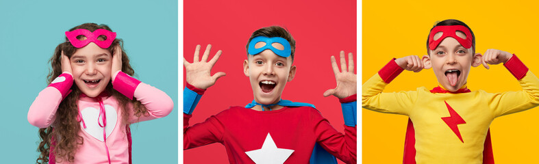Funny children in superhero costumes grimacing