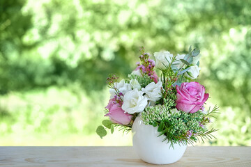 beautiful roses  flowers bouquet on table in garden, natural green background. gentle romantic floral composition. symbol of love and tenderness. Mother's day, wedding, birthday festive concept