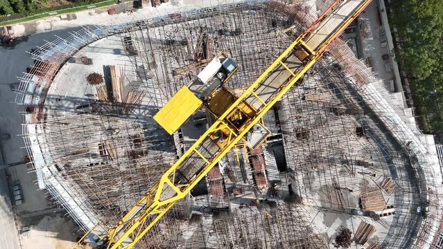 Drone aerial view of crane and construction field in Shanghai China. Construction industry, economy business and travel concept b-roll footage. Top view of the construction site with material workers