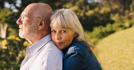 Beautiful elderly couple embracing each other in a park