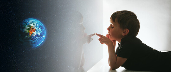 the child looks out the window and dreams that he is in space
