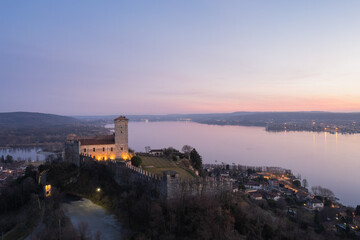 Fototapeta na wymiar Angera Castle at sunset aerial view with Arona city in the background.