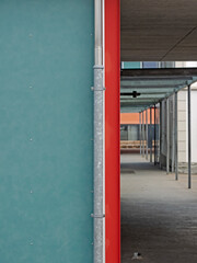 Fototapeta premium Wastewater pipe on a two-tone facade 