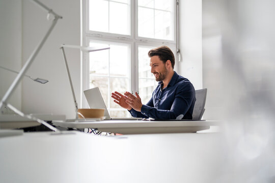 Businessman on video call through laptop in office