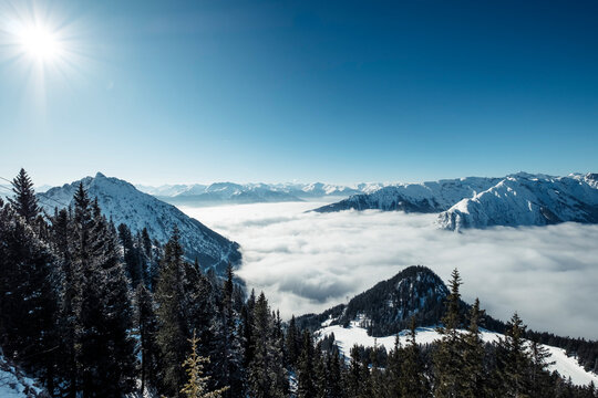 Rofan Mountains on sunny winter day with heavy fog over Achen Lake and Inntal