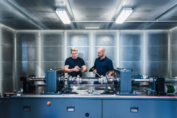 Two colleagues working in modern factory