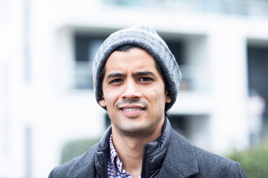 Smiling man wearing gray knit hat