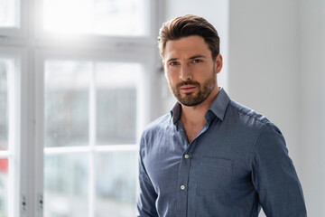 Confident bearded businessman at office