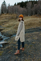 Naklejka premium young woman trees without leaves travel fresh air landscape