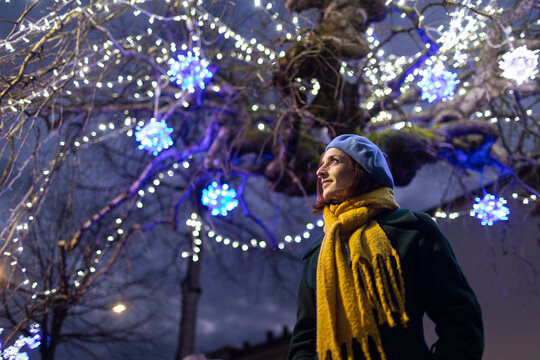 Woman Wearing Yellow Scarf Standing Under Illuminated Tree