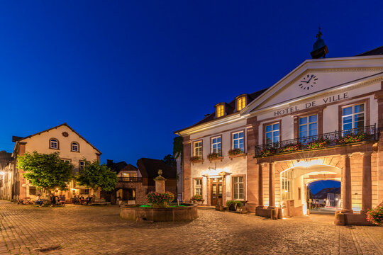 France, Alsace, Ribeauville, Empty town square and illuminated entrance of Hotel de ville at dusk