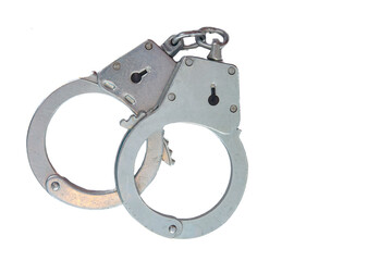 Metal handcuffs on a white isolated background