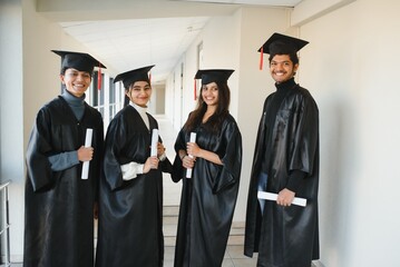 education, graduation and people concept - group of happy international students.