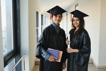 education, graduation and people concept - group of happy indian students