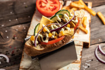 Kebab, pita, gyros, shaurma, wrap sandwich stuffed with sausages from minced meat with grilled meat, vegetables and sauce on dark background. banner, menu, recipe place for text, top view