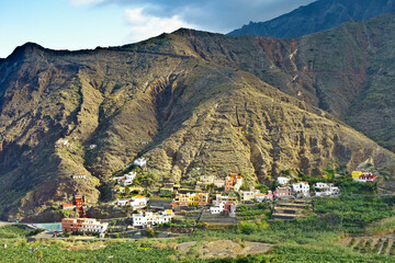 Hermigua village, La Gomera, Canary Islands: Colorful houses on a mountain slope and banana fileds...