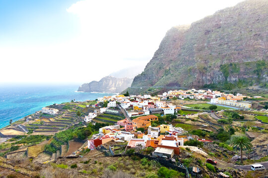 Agulo village, La Gomera, Canary Islands, in winter: colorful houses and terrace fields above the deep blue atlantic ocean.