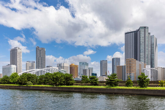 Japan, Kanto Region, Tokyo, Riverside promenade with downtown skyscrapers in background