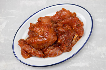 raw meat with marinate on big white dish on ceramic