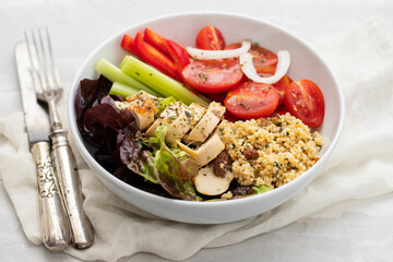 grilled chicken with salad, tabbouleh and fresh vegetables in the bowl