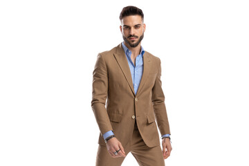 sexy young businessman in brown suit being confident and posing