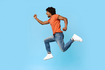 Emotional african american guy running towards copy space