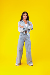 Portrait of happy young woman posing at studio