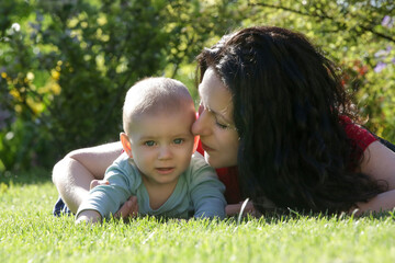 Young mother enjoying a idyllic summer day outdoor with her baby boy
