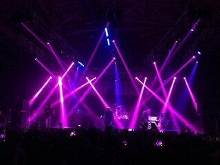 Pink and blue lights above the stage. Laser show at a live performance. Gig, concert. Strobe...