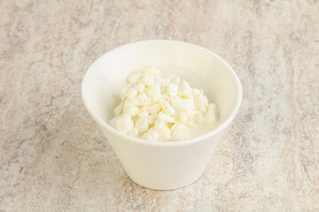 Grained cottage cheese in the bowl