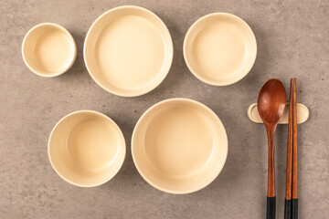 Bowls and tableware on a concrete background