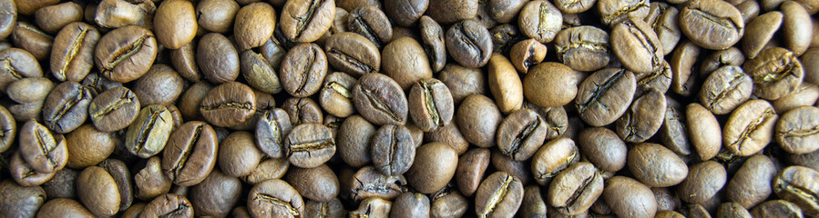 roasted coffee beans close-up. invigorating drink. power engineering specialist. Horizontal image. Banner for insertion into site.