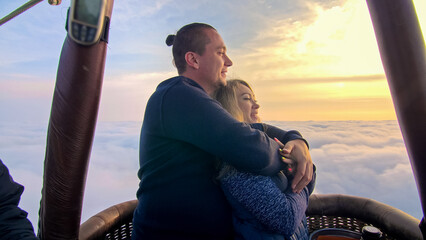Adventure love couple on hot air balloon watermelon. Man and woman kiss hug love each other. Burner...