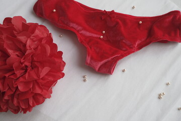 wedding red lingerie on a white texture background. women's health flat lay, periods concept