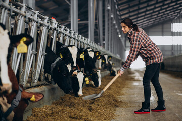 Woman cleaning up at the cowshed