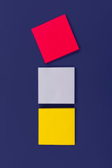 Fototapeta premium Three blank color square sticky note on purple background, top view. Blank space for future important events announcements. Vertical photo