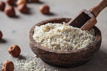 Hazelnut flour in wooden bowl. Alternative nut flour. Keto diet and gluten free concept.