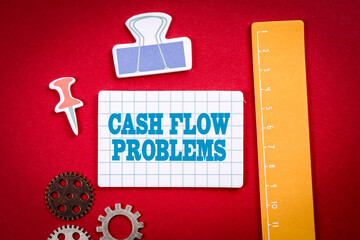 Cash Flow Problems. Office and learning supplies on a red background
