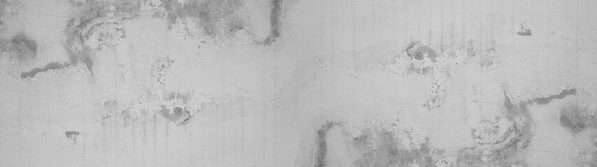 White gray grey damaged weathered plaster stone concrete cement facade wall building architecture texture background panorama banner long.