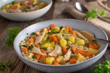 Bean soup or stew with chicken meat, vegetables and potatoes