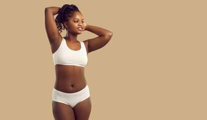 Plus size female model posing in underwear. Beautiful young African woman with curvy figure wearing...