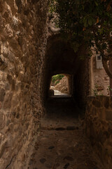 alley in tossa de mar through a narrow tunnel