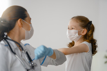 Doctor and child wearing facemasks