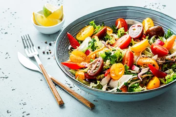 Fotobehang Fresh colorful spring vegetable salad in the blue bowl - healthy organic vegan lunch. © pinkyone