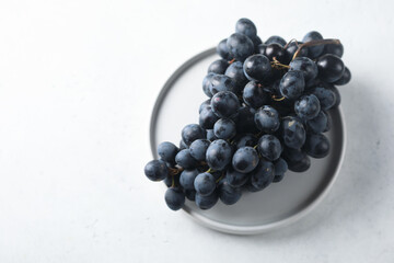 Dark grape on a white plate