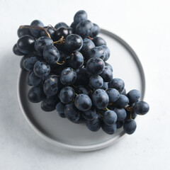 Dark grape on a white plate